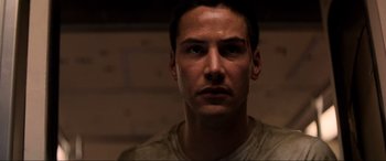 Movie still from “Speed” (1994), directed by Jan de Bont – A person wearing a t - shirt; Close Up shot, Low angle