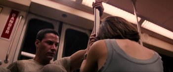 Movie still from “Speed” (1994), directed by Jan de Bont – A man and a woman on a train; Medium shot, Low angle