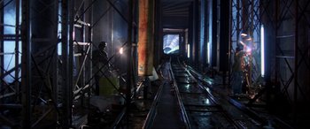 Movie still from “Speed” (1994), directed by Jan de Bont – A man sitting on a train track in a tunnel; Wide shot, High angle