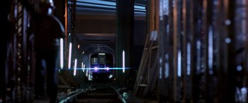Movie still from “Speed” (1994), directed by Jan de Bont – A train is traveling down the tracks in a tunnel; Extreme Wide shot, Low angle