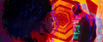 Movie still from “Spider-Man: Across the Spider-Verse” (2023), directed by Joaquim Dos Santos – A woman with a large afro is standing in front of a colorful background; Close Up shot, Low angle