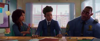 Movie still from “Spider-Man: Across the Spider-Verse” (2023), directed by Joaquim Dos Santos – A man sitting at a table in front of a large window; Medium shot, Over the shoulder angle