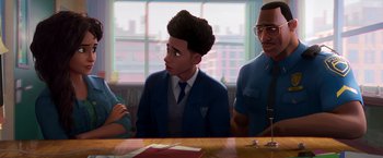 Movie still from “Spider-Man: Across the Spider-Verse” (2023), directed by Joaquim Dos Santos – An illustration of a young boy sitting at a table with his parents; Medium shot, Over the shoulder angle