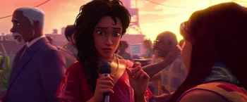 Movie still from “Spider-Man: Across the Spider-Verse” (2023), directed by Joaquim Dos Santos – An animated woman holding a microphone in front of a crowd; Close Up shot, Over the shoulder angle