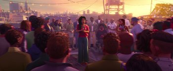 Movie still from “Spider-Man: Across the Spider-Verse” (2023), directed by Joaquim Dos Santos – A group of people gathered around a woman in front of a crowd; Extreme Wide shot, Over the shoulder angle