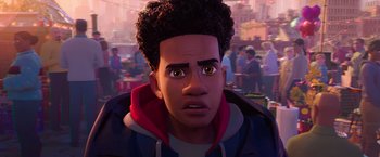 Movie still from “Spider-Man: Across the Spider-Verse” (2023), directed by Joaquim Dos Santos – A young man with curly black hair is looking at the camera; Close Up shot, Over the shoulder angle