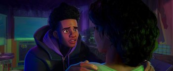 Movie still from “Spider-Man: Across the Spider-Verse” (2023), directed by Joaquim Dos Santos – A man and a woman are talking in a dark room; Close Up shot, Over the shoulder angle