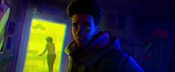 Movie still from “Spider-Man: Across the Spider-Verse” (2023), directed by Joaquim Dos Santos – An animated picture of a young man in a dark room; Medium shot, Over the shoulder angle