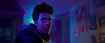 Movie still from “Spider-Man: Across the Spider-Verse” (2023), directed by Joaquim Dos Santos – A person's face in a purple room; Close Up shot, Over the shoulder angle