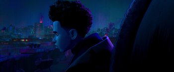 Movie still from “Spider-Man: Across the Spider-Verse” (2023), directed by Joaquim Dos Santos – A young man with curly black hair standing in the dark; Close Up shot, Over the shoulder angle