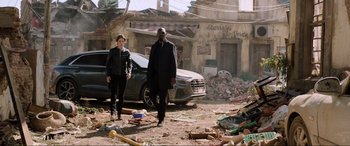 Movie still from “Spider-Man: Far from Home” (2019), directed by Jon Watts – A man and a woman are walking through the rubble; Wide shot, Low angle