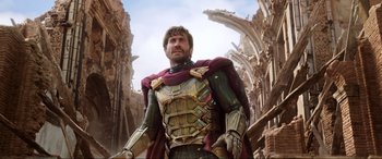 Movie still from “Spider-Man: Far from Home” (2019), directed by Jon Watts – A man wearing a suit of armor stands on a street; Medium shot, Low angle