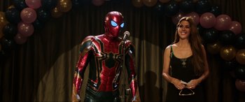 Movie still from “Spider-Man: Far from Home” (2019), directed by Jon Watts – A man dressed as spider - man is on stage; Medium shot, Over the shoulder angle