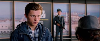 Movie still from “Spider-Man: Far from Home” (2019), directed by Jon Watts – A young man in front of a picture of a man in uniform; Close Up shot, Over the shoulder angle