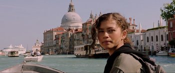Movie still from “Spider-Man: Far from Home” (2019), directed by Jon Watts – A woman standing in front of a building on the water; Close Up shot, Low angle