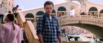 Movie still from “Spider-Man: Far from Home” (2019), directed by Jon Watts – A man in a plaid shirt and a blue backpack; Medium shot, Over the shoulder angle