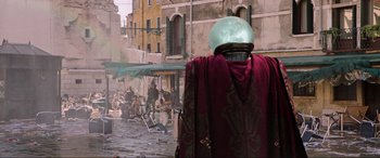 Movie still from “Spider-Man: Far from Home” (2019), directed by Jon Watts – A person wearing a helmet and a red cape; Wide shot, Over the shoulder angle