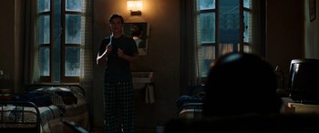 Movie still from “Spider-Man: Far from Home” (2019), directed by Jon Watts – A man standing in front of a mirror in a room; Medium shot, Over the shoulder angle