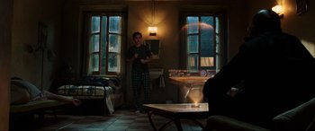 Movie still from “Spider-Man: Far from Home” (2019), directed by Jon Watts – A man standing in a room with a remote control; Wide shot, Over the shoulder angle
