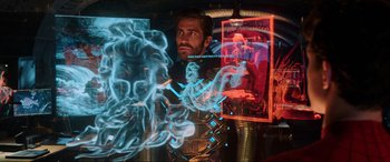 Movie still from “Spider-Man: Far from Home” (2019), directed by Jon Watts – A man is looking at a picture on a wall; Medium shot, Over the shoulder angle