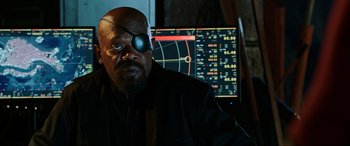 Movie still from “Spider-Man: Far from Home” (2019), directed by Jon Watts – A man wearing a eye patch sitting in front of a computer screen; Close Up shot, Over the shoulder angle