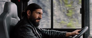 Movie still from “Spider-Man: Far from Home” (2019), directed by Jon Watts – A man with long hair and a goatee sitting in front of a window; Close Up shot, Over the shoulder angle