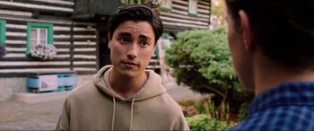 Movie still from “Spider-Man: Far from Home” (2019), directed by Jon Watts – A young man in a tan hoodie standing in front of a building; Close Up shot, Over the shoulder angle