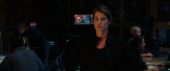 Movie still from “Spider-Man: Far from Home” (2019), directed by Jon Watts – A woman standing in front of a television; Medium shot, Over the shoulder angle