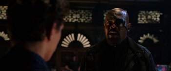 Movie still from “Spider-Man: Far from Home” (2019), directed by Jon Watts – A man with a goatee is talking to a woman; Close Up shot, Over the shoulder angle