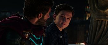 Movie still from “Spider-Man: Far from Home” (2019), directed by Jon Watts – A man standing next to another man in a room; Close Up shot, Over the shoulder angle
