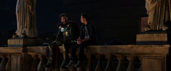 Movie still from “Spider-Man: Far from Home” (2019), directed by Jon Watts – Two people sitting on a bench in front of a wall; Wide shot, Over the shoulder angle