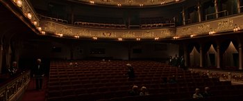 Movie still from “Spider-Man: Far from Home” (2019), directed by Jon Watts – People are sitting in a theater while a man walks in the background; Extreme Wide shot, High angle