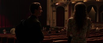 Movie still from “Spider-Man: Far from Home” (2019), directed by Jon Watts – A man and a woman are standing in a theater; Medium shot, Over the shoulder angle
