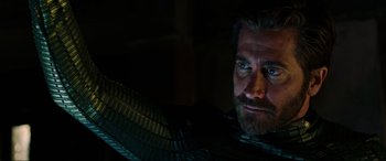 Movie still from “Spider-Man: Far from Home” (2019), directed by Jon Watts – A person with a beard looking at the camera; Close Up shot, Over the shoulder angle