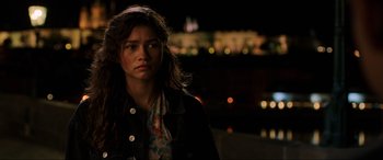 Movie still from “Spider-Man: Far from Home” (2019), directed by Jon Watts – A woman standing in front of a building at night; Close Up shot, Over the shoulder angle