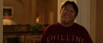 Movie still from “Spider-Man: Far from Home” (2019), directed by Jon Watts – A man smiling for the camera while wearing a t - shirt; Medium shot, High angle