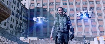 Movie still from “Spider-Man: Far from Home” (2019), directed by Jon Watts – A man standing in front of a tall building; Wide shot, Low angle