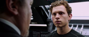 Movie still from “Spider-Man: Far from Home” (2019), directed by Jon Watts – A young man looking into a mirror in a room; Close Up shot, Over the shoulder angle