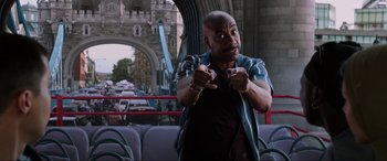 Movie still from “Spider-Man: Far from Home” (2019), directed by Jon Watts – A man in a blue shirt is on a bus; Medium shot, Low angle