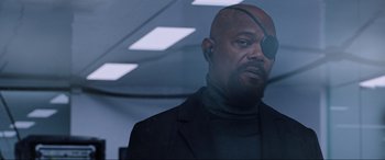 Movie still from “Spider-Man: Far from Home” (2019), directed by Jon Watts – A man in a black jacket with a eye patch on; Close Up shot, Over the shoulder angle