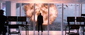 Movie still from “Spider-Man: Far from Home” (2019), directed by Jon Watts – A man standing in front of an exploding window; Extreme Wide shot, Over the shoulder angle