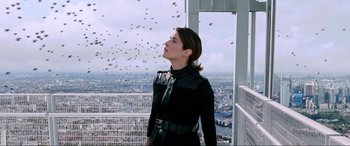 Movie still from “Spider-Man: Far from Home” (2019), directed by Jon Watts – A woman standing on top of a building looking at the sky; Medium shot, Low angle