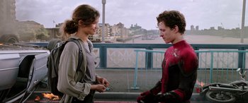 Movie still from “Spider-Man: Far from Home” (2019), directed by Jon Watts – A man and a woman standing next to each other on a bridge; Medium shot, Over the shoulder angle