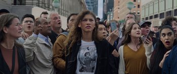 Movie still from “Spider-Man: No Way Home” (2021), directed by Jon Watts – A crowd of people standing on the side of a street; Medium shot, Over the shoulder angle