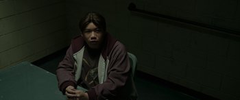 Movie still from “Spider-Man: No Way Home” (2021), directed by Jon Watts – A person sitting in a chair in a room; Medium shot, High angle