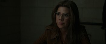 Movie still from “Spider-Man: No Way Home” (2021), directed by Jon Watts – A person wearing glasses and a brown jacket; Close Up shot, Over the shoulder angle