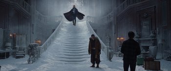 Movie still from “Spider-Man: No Way Home” (2021), directed by Jon Watts – A man walking down a snow covered stair case; Wide shot, Low angle