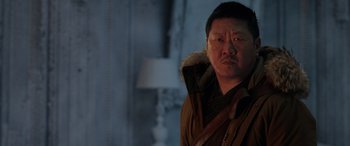 Movie still from “Spider-Man: No Way Home” (2021), directed by Jon Watts – A man in a parka standing next to a lamp; Close Up shot, Over the shoulder angle