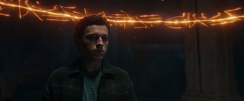 Movie still from “Spider-Man: No Way Home” (2021), directed by Jon Watts – A man in a green jacket is in front of a blurry background; Close Up shot, Low angle