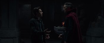 Movie still from “Spider-Man: No Way Home” (2021), directed by Jon Watts – Two men are talking in a dark room; Medium shot, Over the shoulder angle